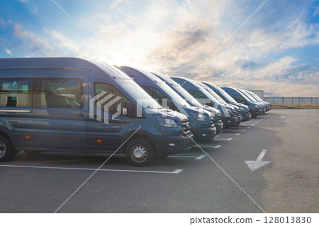 Series of new vans are parked in rows 128013830