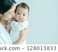 A woman holding a baby 128013833