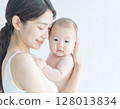A woman holding a baby 128013834