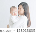 A woman holding a baby 128013835