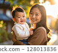 A woman holding a baby 128013836