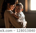 A woman holding a baby 128013840