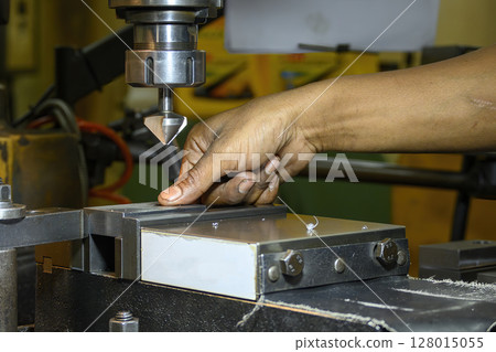 The machine operator working with NC milling machine. 128015055