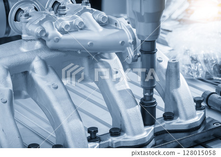 Automotive parts assembly process by the power wrench in the light blue scene. 128015058