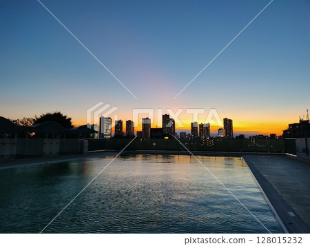 Outdoor pool sunset 128015232