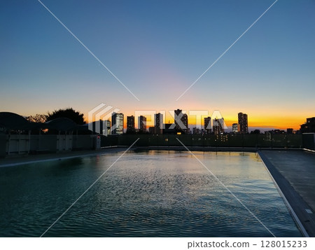 Outdoor pool sunset 128015233