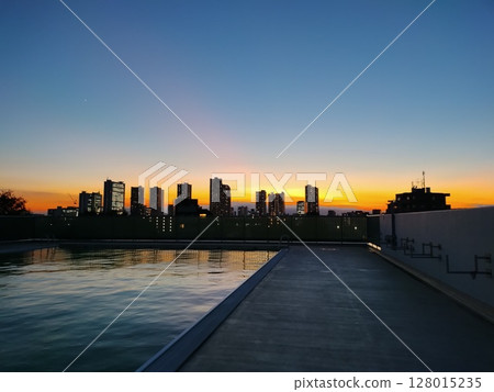 Outdoor pool sunset 128015235