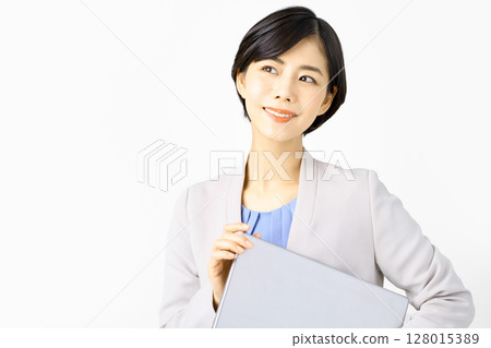 Business woman in a suit with a laptop Business woman in a suit with a laptop 128015389