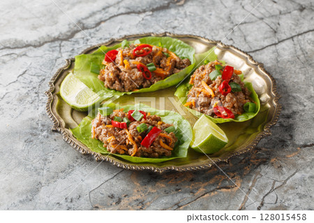 Asian Ground Beef Lettuce Wraps cups with vegetables close-up on the plate. Horizontal 128015458