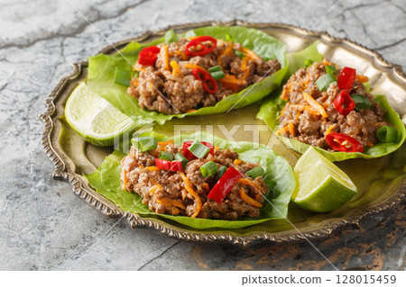 Ground Beef Lettuce Wraps with vegetables close-up on the plate. Horizontal 128015459