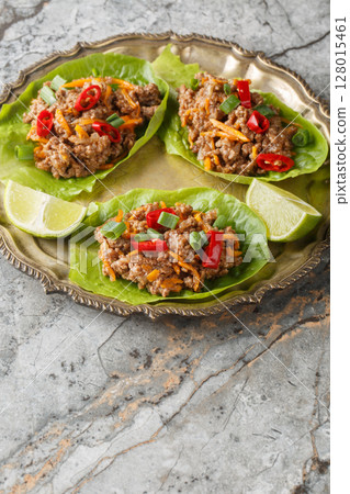 Juicy Thai Beef Lettuce Cups close-up on the plate. Vertical Juicy Thai Beef Lettuce Cups close-up on the plate. Vertical 128015461