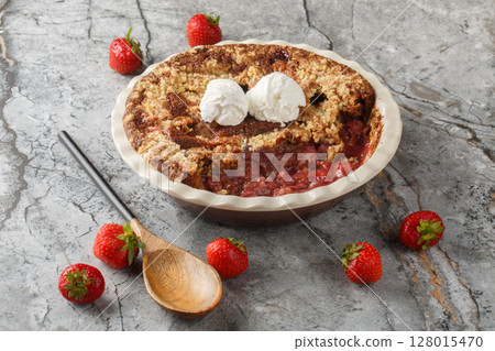 Summer dessert cocoa strawberry cobbler with vanilla ice cream close-up in baking dish. horizontal 128015470