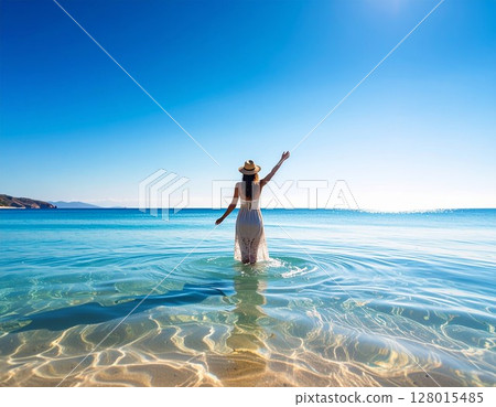 A woman in a white dress and the clear blue sea 128015485