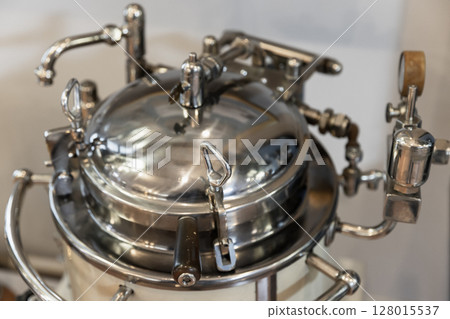 Intricate vintage metal machine featuring industrial elements 128015537