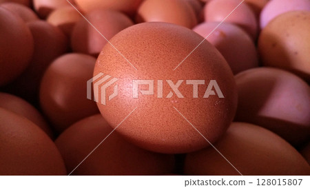 Close-Up of Brown Chicken Egg with Natural Texture.  128015807