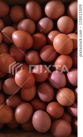Vertical Full Frame Image of Brown Chicken Eggs in Natural Light. Vertical Full Frame Image of Brown Chicken Eggs in Natural Light. 128015809