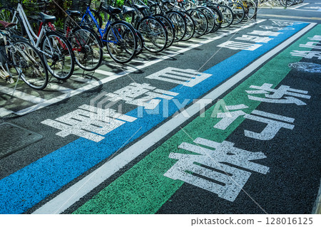 Bicycle parking on the street at night - designated areas for bicycles and pedestrians 128016125