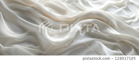 Soft, white fabric drapes in elegant waves, creating a luxurious and calming background. 128017105