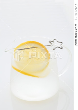 Meyer lemon cut into pieces and a pitcher of lemon water Meyer lemon cut into pieces and a pitcher of lemon water 128017654