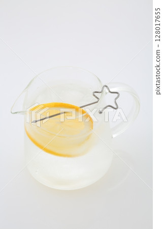 Meyer lemon cut into pieces and a pitcher of lemon water 128017655