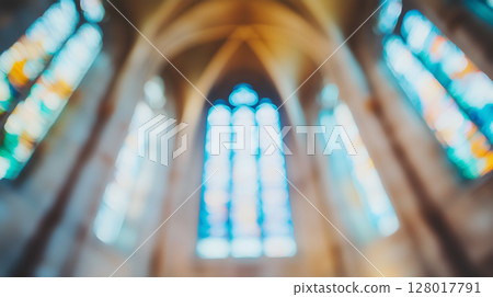 Stained glass windows of an ancient church illuminated by the afternoon sun 128017791