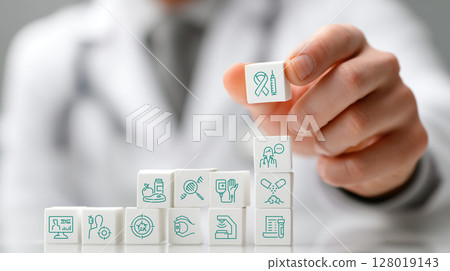 Oncology doctor arranges white blocks with medical symbols, symbolizing cancer treatment and solutions. scene conveys sense of precision and care 128019143