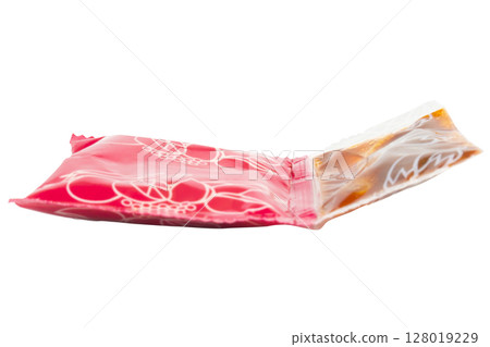 Red instant noodle seasoning packet on white background 128019229