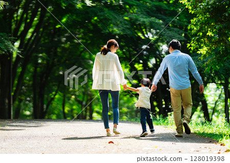 The back of a family walking with hands 128019398
