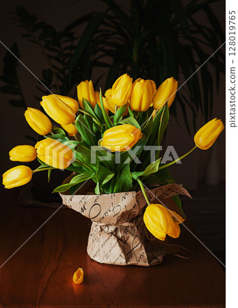 yellow tulips on a wooden background 128019765