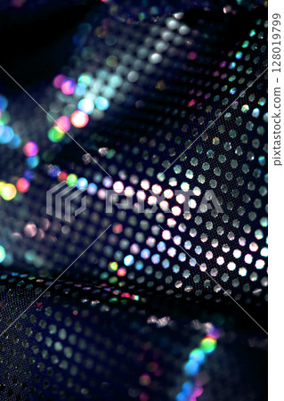 Holographic shiny spots and dots bokeh on fabric for a futuristic disco background 128019799