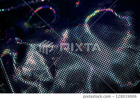 Holographic shiny spots and dots bokeh on fabric for a futuristic disco background 128019806