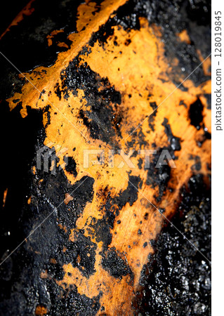 Close up of heavy black rust on a brass base of a kitchen sauce pan abstract background Close up of heavy black rust on a brass base of a kitchen sauce pan abstract background 128019845