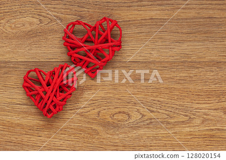 Two Red Heart-Shaped Decorations on Rustic Wooden Surface Two Red Heart-Shaped Decorations on Rustic Wooden Surface 128020154