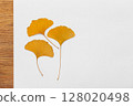 Dry Ginkgo Leaves Arranged on a Minimalist White Background 128020498