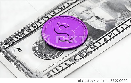 Vibrant purple coin adorns a weathered dollar bill invoking financial contrast 128020691