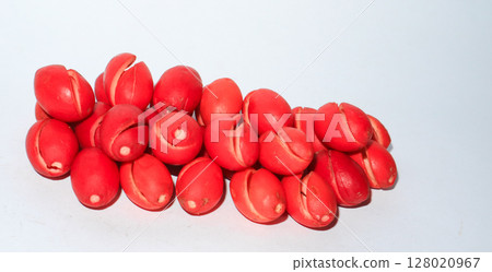 Red melinjo or gnetum gnemon skin on white background. Decorative design. Ingredient vegetable 128020967