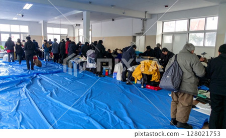 Elderly people receiving relief supplies 128021753