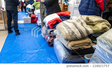 Elderly people receiving relief supplies 128021757