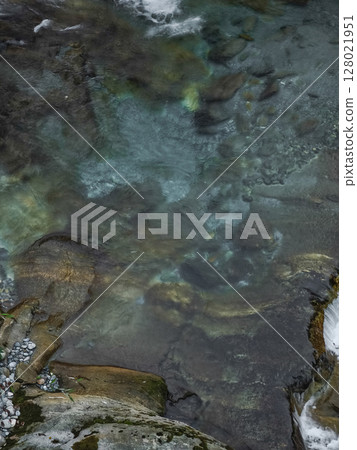 Water cascading over polished rocks in aosta valley, revealing autumnal tranquility with crystalline textures and soft light pontboset 128021951