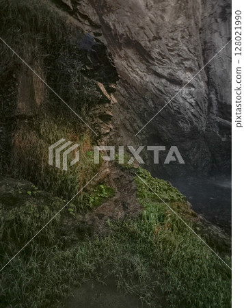 Rocky cliffs near aosta embracing verdant foliage, highlighting alpine landscape's lush greenery during late autumn's peaceful moments Isollaz waterfall Rocky cliffs near aosta embracing verdant foliage, highlighting alpine landscape's lush greenery during late autumn's peaceful moments Isollaz waterfall 128021990