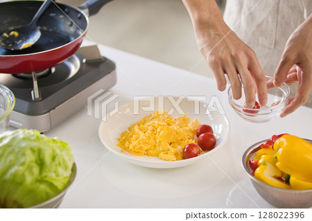 Hands of a young man preparing egg dishes 128022396