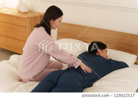 Wife giving her husband a massage 128022517