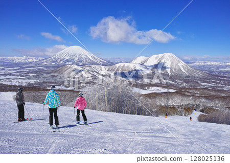 Skiers looking at Mt. Yotei before a run at Rusutsu Ski Resort in mid-winter Skiers looking at Mt. Yotei before a run at Rusutsu Ski Resort in mid-winter 128025136