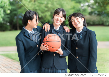 Smiling female junior high school student and high school student (basketball club) holding a basketball Smiling female junior high school student and high school student (basketball club) holding a basketball 128025357