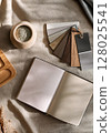 Interior design desk with wood grain samples and notebooks 128025541