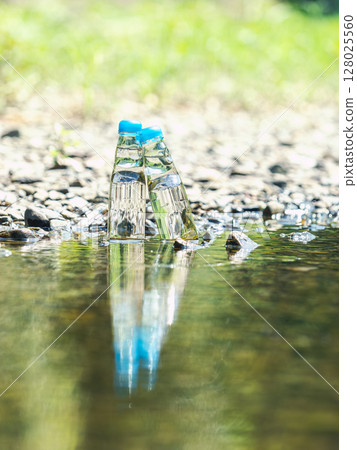 Two bottles of Ramune cooled with cold river water in summer 128025560