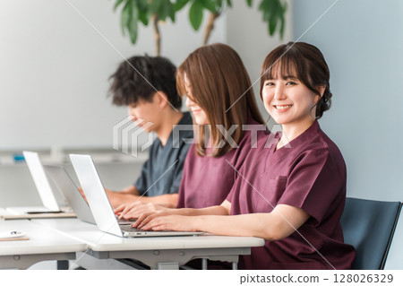Medical, conference, study session, seminar, training, male and female medical staff in scrubs receiving training Medical, conference, study session, seminar, training, male and female medical staff in scrubs receiving training 128026329