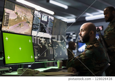 Counterterrorism division operative using target acquisition tech on isolated screen gear to detect enemy location. Defense security expert using chroma key satellite hardware to track threats 128026416