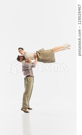 Man lifting woman in retro dance pose against white background. Poster, flyer 128026467