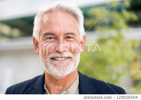 Smiling senior businessman looking at camera Smiling senior businessman looking at camera 128026504
